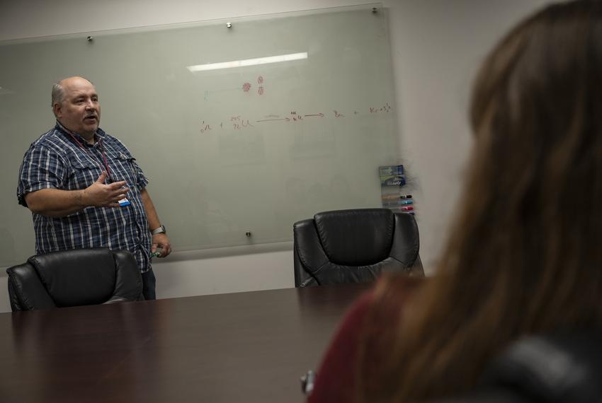 Texas A&M University Nuclear Engineering instructional professor Cable Kurwitz diagrams a simple explanation for the process of nuclear fission Monday, March 11, 2024 in College Station.