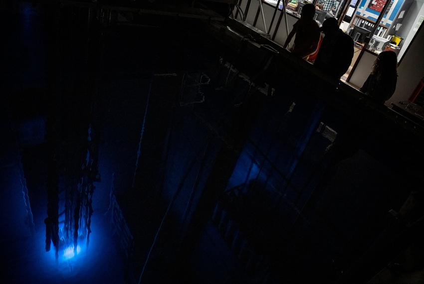 Reactor operators peer into the reactor pool to look at a blue glow emitting from Texas A&M University’s Training, Research, Isotopes, General Atomics (TRIGA) nuclear research reactor Monday, March 11, 2024 in College Station.