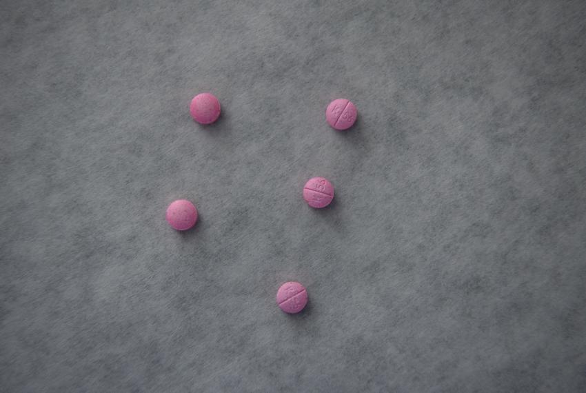 A group of counterfeit K56 pills, which contain fentanyl, is displayed as tests are conducted on seized drugs at the Houston Forensic Science Center in Houston on March 29, 2023.