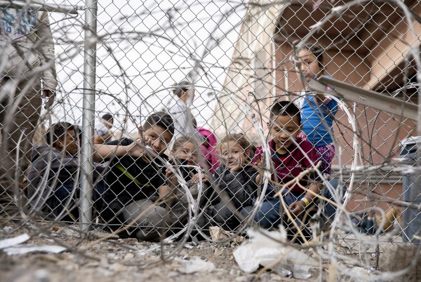 A group of kids are seen inside a temporary migrant holding area set up by Customs and Border Protection under the Paso del Norte International Port of Entry between Juarez and El Paso, on March 27, 2019.