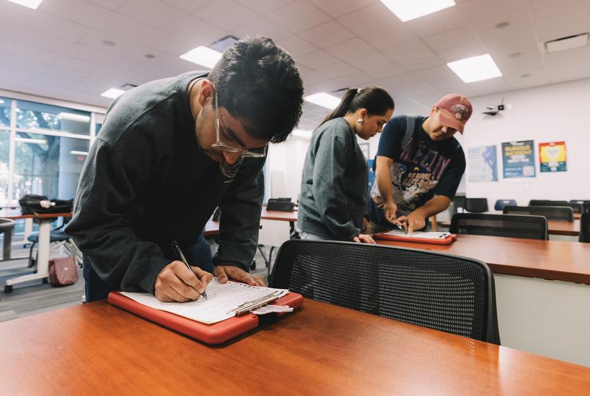 On the left, Mihir Relan, 18, and Bianca Juarez, 18, registers to vote with the help of Jolt Initiative, a non-profit organization that increases the civic participation of Latinos in Texas, on Friday, April 5, 2024.