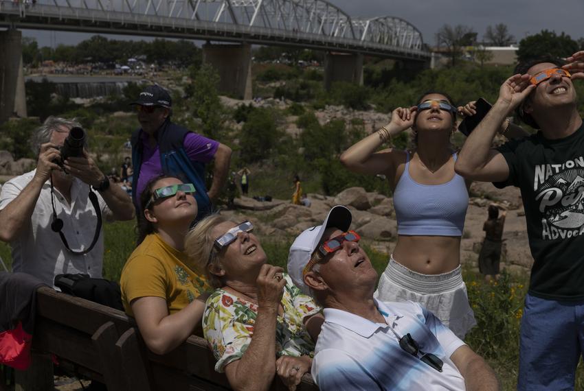 The Baressi family looks up at the sun Grenwelge Park, minutes before the total solar eclipse’s totality in Llano on April 8, 2024. The family traveled from across the United States to view the eclipse. The eclipse is expected to bring thousands of visitors to the area.