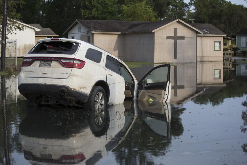 An abandoned car sits in floodwaters in a residential neighborhood in Beaumont September 5, 2017, 11 days days after Hurricane Harvey ravaged the Texas Coast. Thousands of residents continue to live in shelters almost two weeks after the storm.