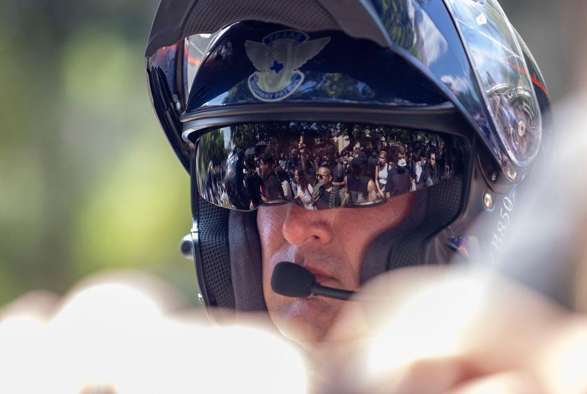 A Texas Department of Public Safety trooper stands between a pro-Palestinian encampment and other ralliers on the University of Texas at Austin campus on Monday, April 29, 2024