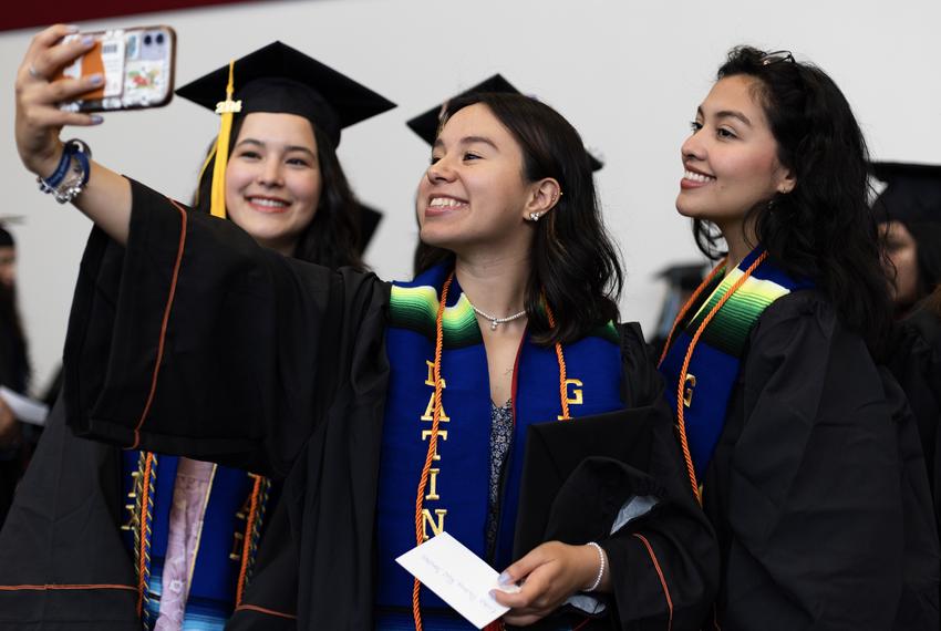 Latinx graduates take a selfie prior to University of Texas at Austin Latinx Graduation on Thursday, May 9, 2024 in Austin. Graduates took time prior to the ceremony to talk with friends, take photos with each other and fix their hair and regalia.
