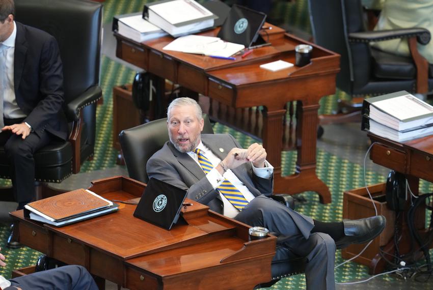 State Sen. Drew Springer, R-Muenster, sits on the floor during the afternoon session of Day 1 of the Ken Paxton impeachment trial in the Texas Senate.