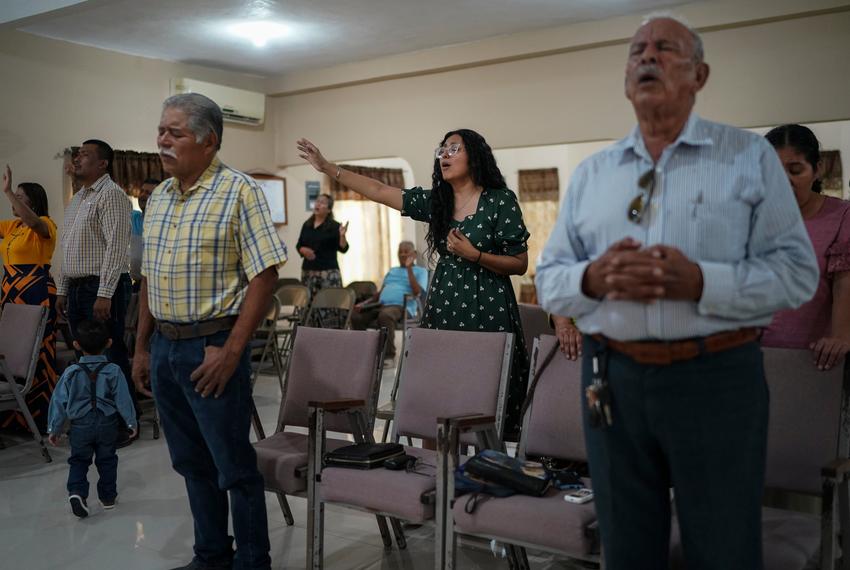 Claudia González, 36, worships at her church in Tamaulipas, México on Sept. 17, 2023. After living in Texas for two decades and receiving a work permit through DACA, she applied for her green card, hoping to become a legal permanent U.S. resident.
