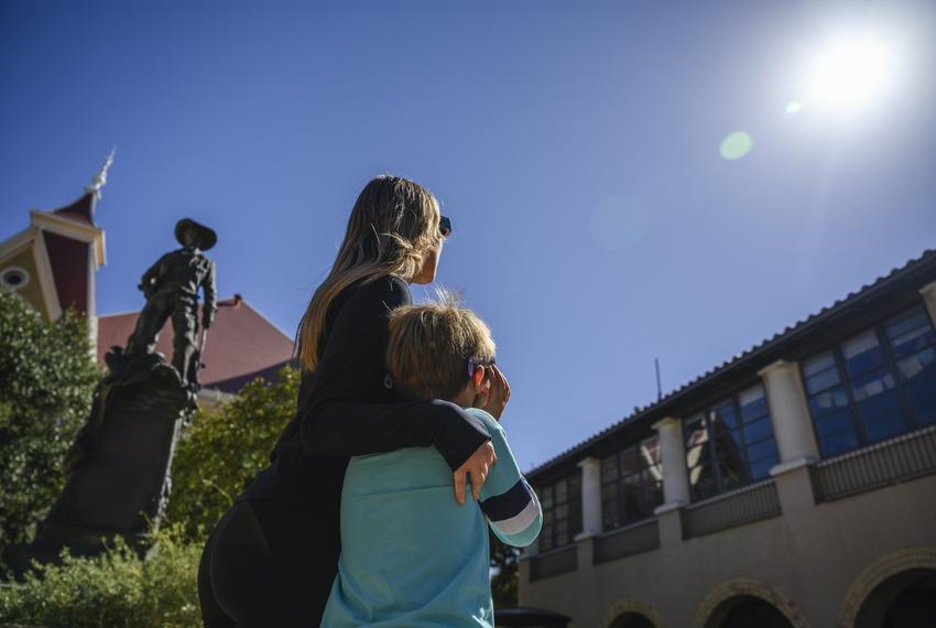 Perry Mason, left, points out the solar eclipse to her son Mason Shaddock, 9, during its annularity Oct. 14, 2023, in San Marcos,