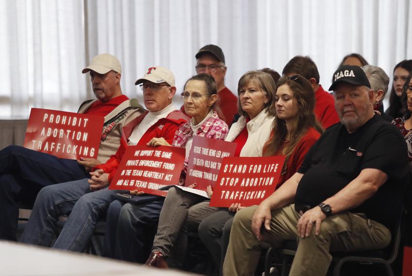 Anti-abortion supporters listen as members of the Amarillo City Council meet to consider a so-called abortion travel ban during a work session Tuesday, Dec. 19, 2023 in Amarillo. The council has debated the issue since October.