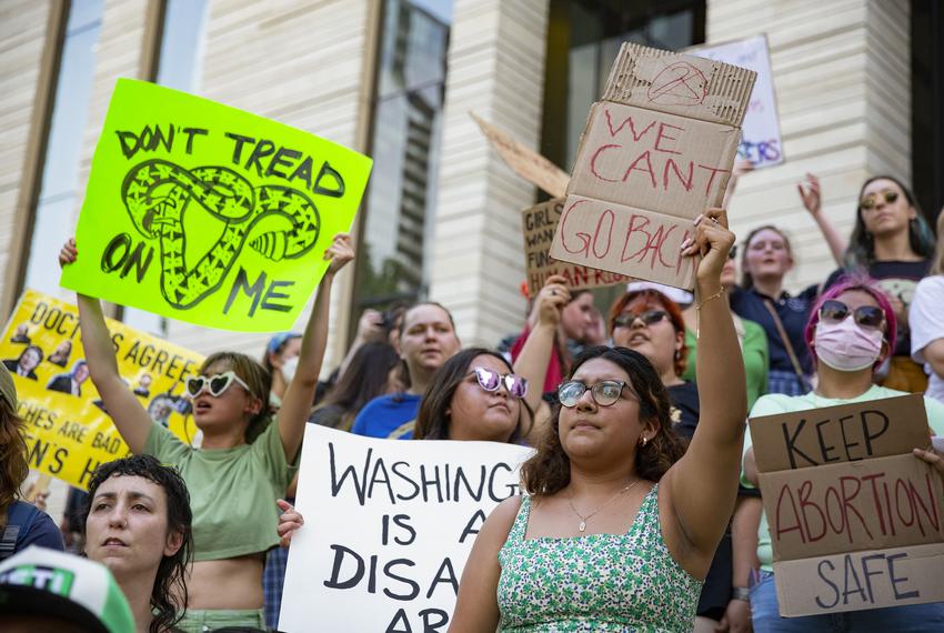 Protesters hold signs during the abortion rights rally in downtown Austin on May 3, 2022.