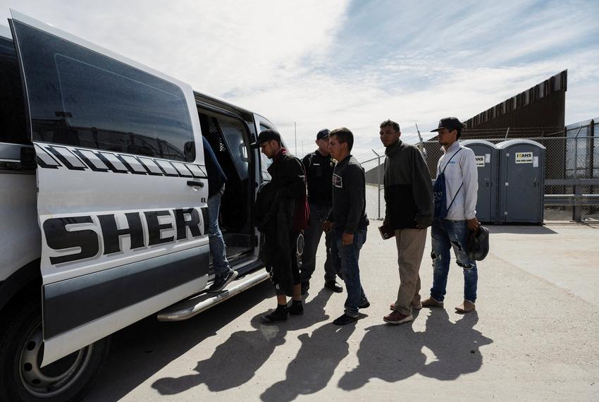 A group of migrants walk to an El Paso County Sheriff transport van to be taken to processing on the day the U.S. 5th Circuit Court of Appeals hears oral arguments on Texas' motion to lift a block an immigration law that would allow state officials to arrest migrants suspected of being in the country illegally, in El Paso, on March 20, 2024.