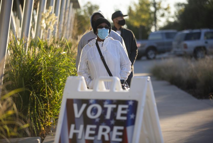 Voters stand in line at Highland Hills Library to cast their ballots on Election Day in Dallas. Nov. 3, 2020. 