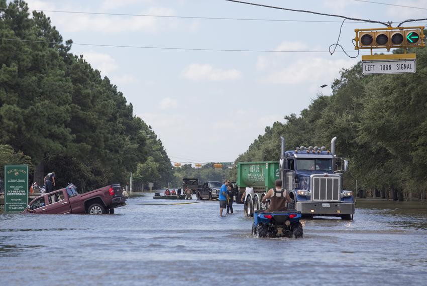 Rescuers and volunteers help evacuate a neighborhood along Eldridge Parkway flooded by waters released from Addicks Reservoir on Aug. 30, 2017, in Houston, added to flooding from Hurricane Harvey.