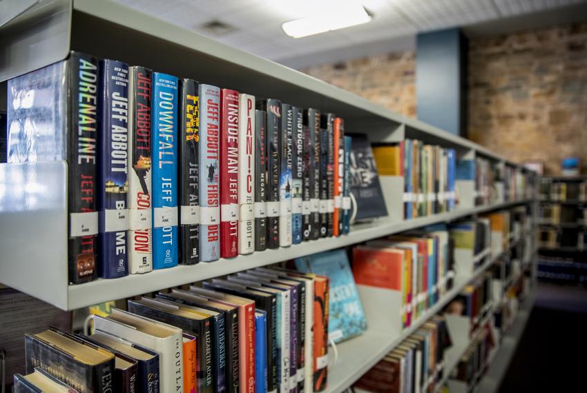 Books on shelves at the Llano Public Library on Dec. 14, 2021. The Commissioners Court for Llano County voted to close the public library to conduct "inventory and catalog" their books after community pushback related to books that some deemed offensive. The pushback also led to a decision to immediately shut down an online library of thousands of books out of fears that children could access material not appropriate for children.