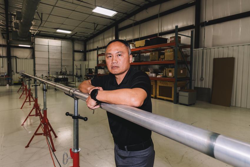 Henry Phan, vice president of engineering for Quaise Energy, poses for a portrait with a wave guide in Houston, on Thursday, Feb. 15, 2024. (Joseph Bui for The Texas Tribune)