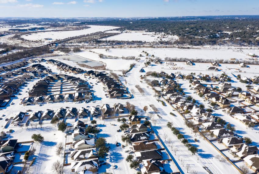 The Blanco Vista neighborhood of San Marcos is blanketed with several inches of snow as a massive winter weather system causes power outages across Texas on Feb. 15, 2021.