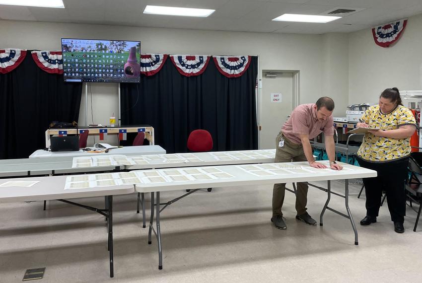 Gillespie elections staffer Alan Littman, left, and election worker, Joy Smith, review precinct totals at the county’s election office to aggregate election results before submitting them to the Texas Secretary of State’s office on March 14, 2024.